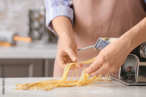 Woman making pasta with mac...