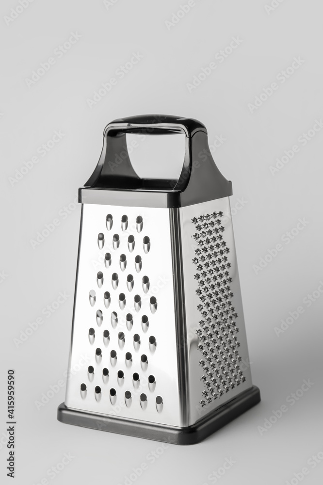 Metal grater on grey background Metal grater on grey background