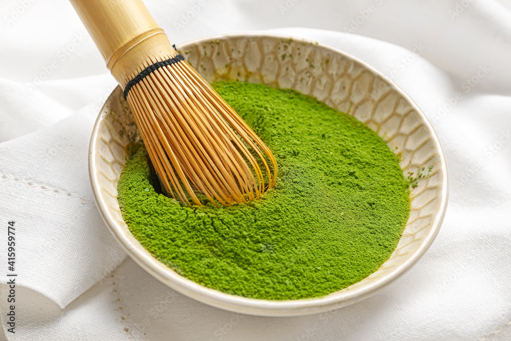 Bowl with powdered matcha tea and chasen on light background, closeup Bowl with powdered matcha tea and chasen on light background, closeup