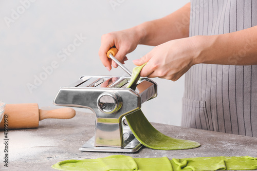 Woman with dough and pasta ...