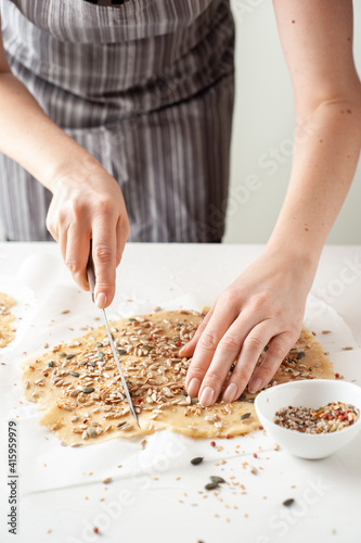 A woman cooks vegan cookies. Healthy food. Homemade sweets. Experiments with food. Vertical photo.