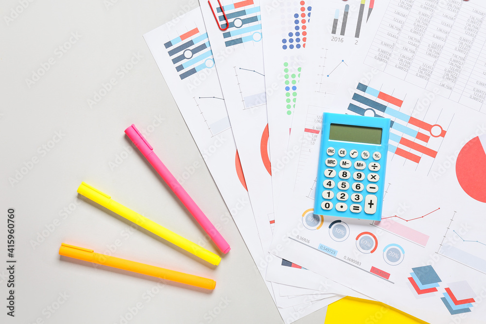 Modern calculator and documents on grey background Modern calculator and documents on grey background