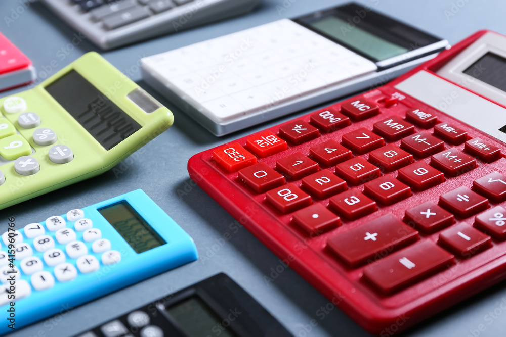 Modern calculators on grey background Modern calculators on grey background