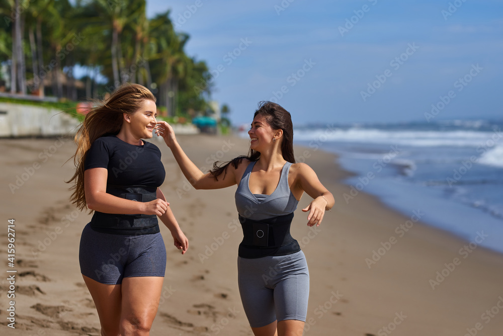 Two young girls in the sweat belt are engaged in fitness. Weight loss belt Two young girls in the sweat belt are engaged in fitness. Weight loss belt