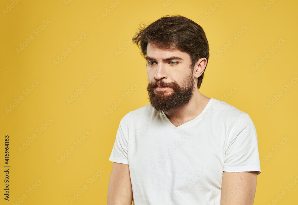 Obraz premium Portrait of handsome man yellow background beard brunette model