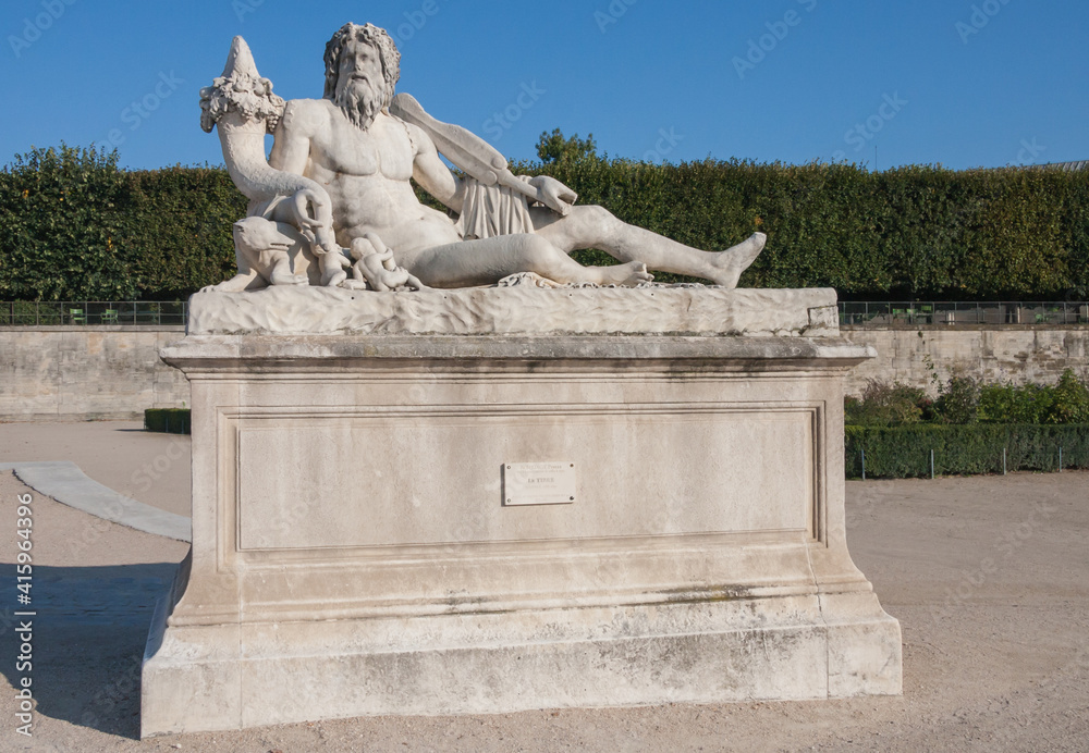 Le Tibre (The Tibor) marble statue in the Tuileries Garden on an autumn day with clear blue sky in Paris, France