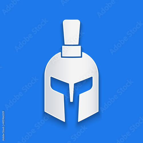 Paper cut Greek helmet icon isolated on blue background. Antiques helmet for head protection soldiers with a crest of feathers or horsehair. Paper art style. Vector.