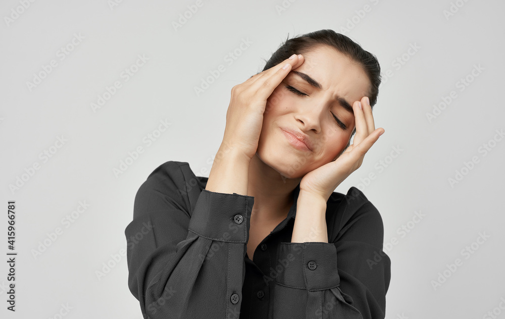 brunette in shirt holding face health problems discontent brunette in shirt holding face health problems discontent