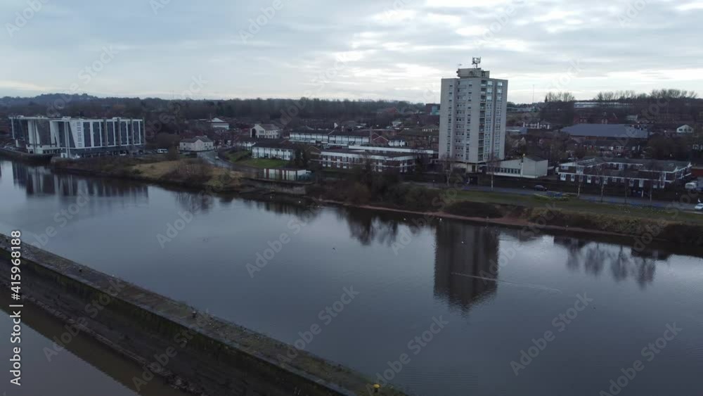 Aerial view flying old British town regeneration waterfront apartments block along waterway channel orbit wide left Aerial view flying old British town regeneration waterfront apartments block along waterway channel orbit wide left