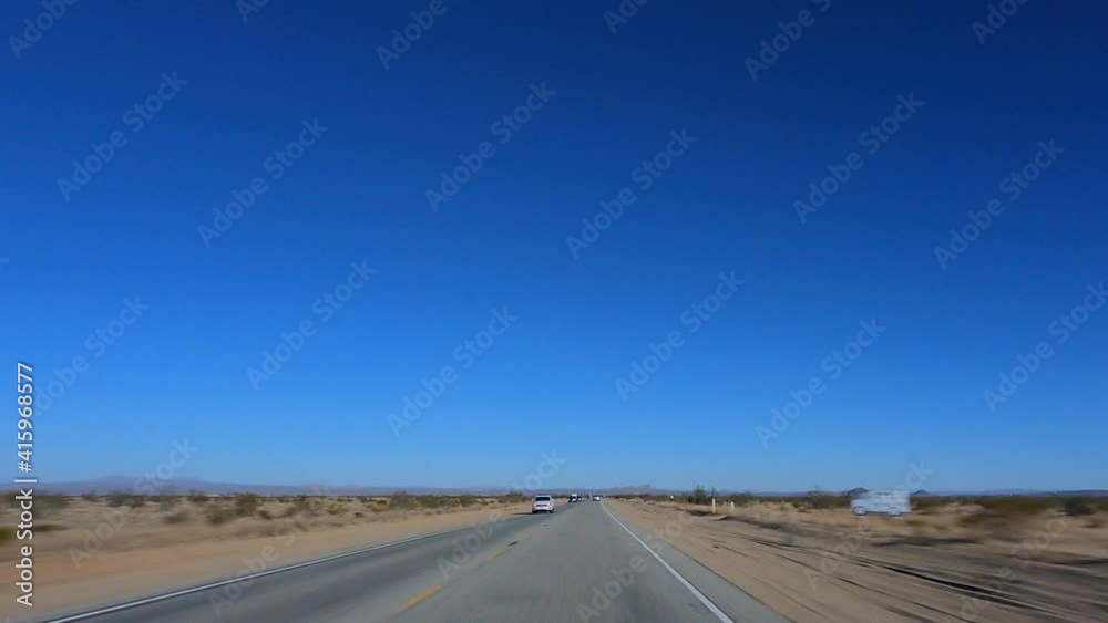 Driving through the Mojave Desert on a bright day with a clear blue sky - point of view hyper lapse Driving through the Mojave Desert on a bright day with a clear blue sky - point of view hyper lapse