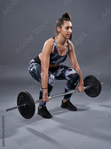 Young woman doing deadlift