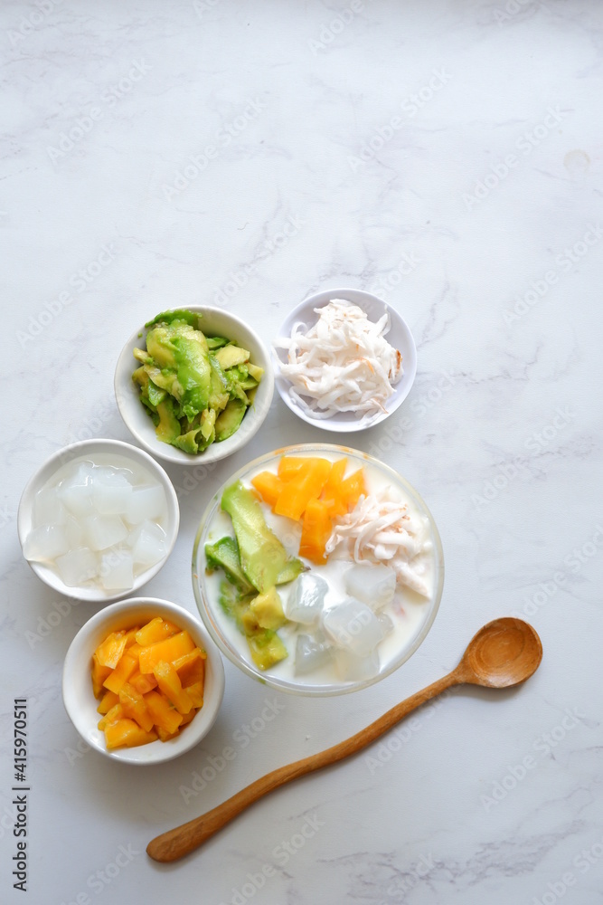 a glass of es teler or various fruits with coconut milk soup and ice cubes a glass of es teler or various fruits with coconut milk soup and ice cubes