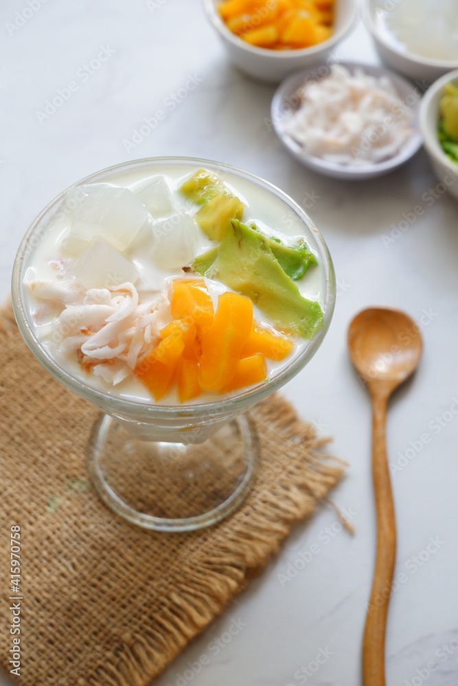 a glass of es teler or various fruits with coconut milk soup and ice cubes a glass of es teler or various fruits with coconut milk soup and ice cubes