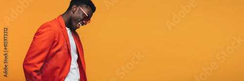 Handsome african fashion model on orange background