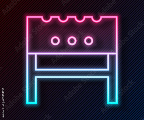 Glowing neon line BBQ brazier icon isolated on black background. Vector.