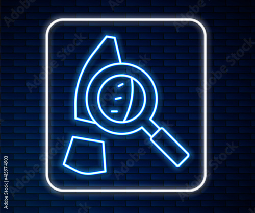 Glowing neon line Magnifying glass with footsteps icon isolated on brick wall background. Detective is investigating. To follow in the footsteps. Vector.