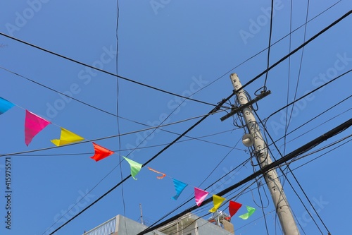 The various colored flags hanging on the telephone pole