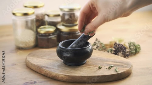 the scientist doctor is making natural herb medicine or cosmetic in the laboratory.