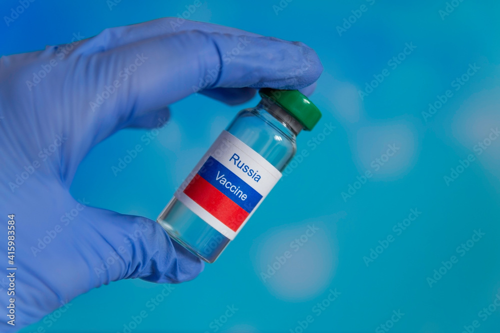 Vaccine Russia vial dose flu shot drug needle syringe,medical concept vaccination hypodermic injection treatment disease care hospital prevention immunization illness disease child. blue background Vaccine Russia vial dose flu shot drug needle syringe,medical concept vaccination hypodermic injection treatment disease care hospital prevention immunization illness disease child. blue background