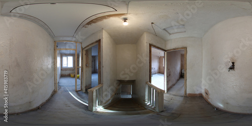 360 Degree panoramic sphere photo of construction working being done on an old British terrace house showing the hallway and main stairs with wooden floors in the house