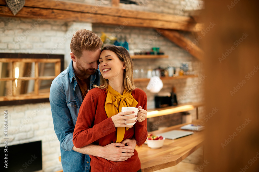 © Drazen - Affectionate couple enjoying in their love while embracing at home.