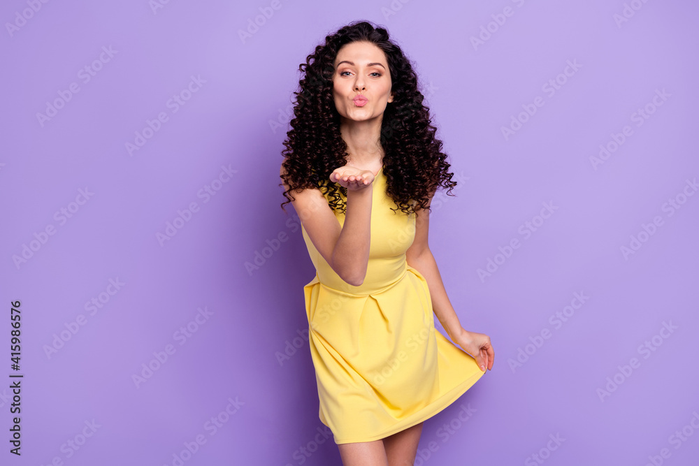 Photo of adorable lady arm palm send air kiss you hold dress have good mood isolated on violet color background Photo of adorable lady arm palm send air kiss you hold dress have good mood isolated on violet color background
