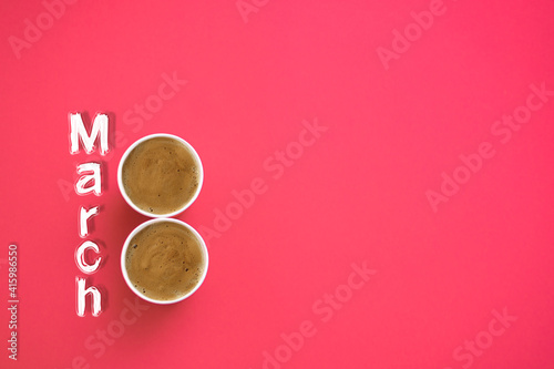 Two paper cups of morning coffee in the shape of the number 8. On a red background. The inscription is March 8. The concept of congratulations on March 8. View from above. Copy space for text