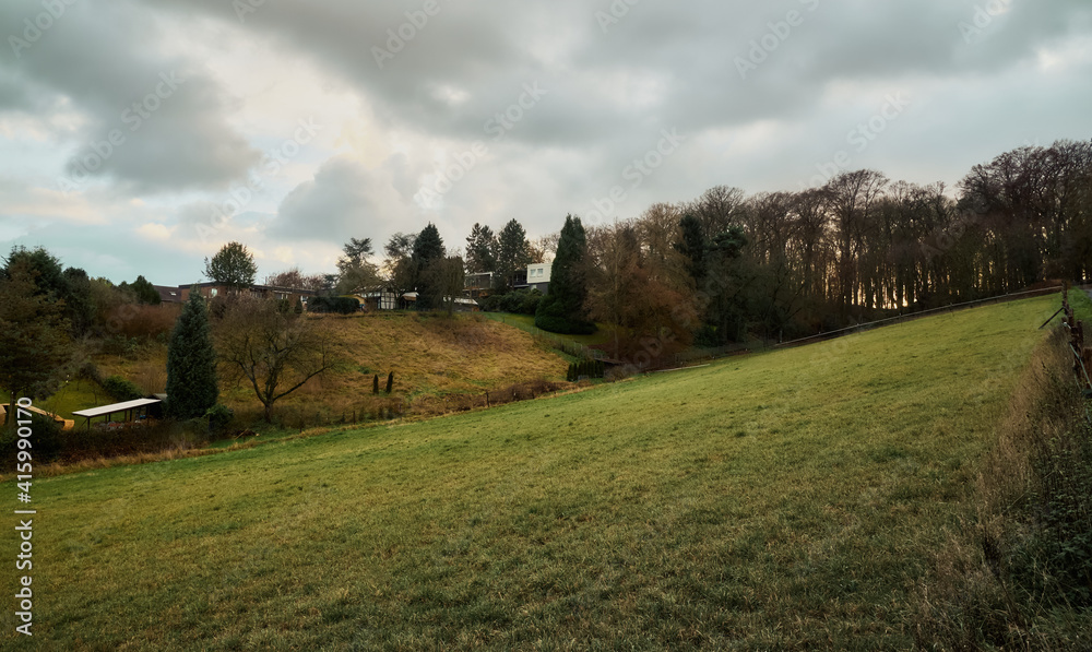 Autumn landscape, evening in the village, a beautiful lawn.
