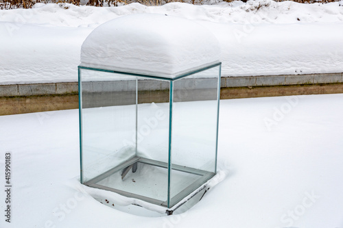 Large glass transparent cube as an element of garden or courtyard decoration