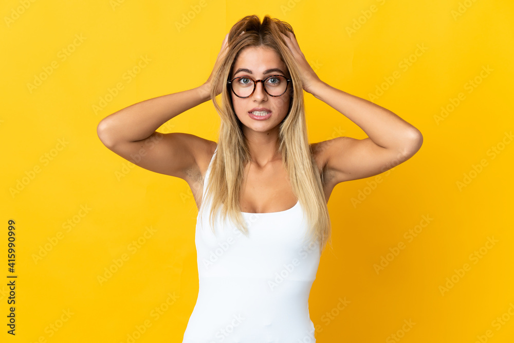 Young blonde woman isolated on yellow background doing nervous gesture Young blonde woman isolated on yellow background doing nervous gesture