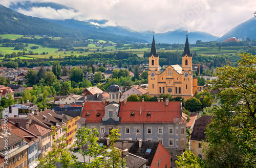 Obraz na płótnie Church of the Assumption of Mary in the old town of Brunico (Bruneck), South Tyrol, Italy. Top view of the historic center of the old city. w salonie