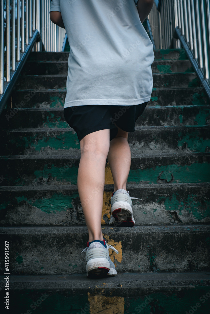 Hiit workout cardio running jogging up the stairs training. Staircase climbing run woman going run up steps. Runner athlete doing cardio sport workout. Hiit workout cardio running jogging up the stairs training. Staircase climbing run woman going run up steps. Runner athlete doing cardio sport workout.