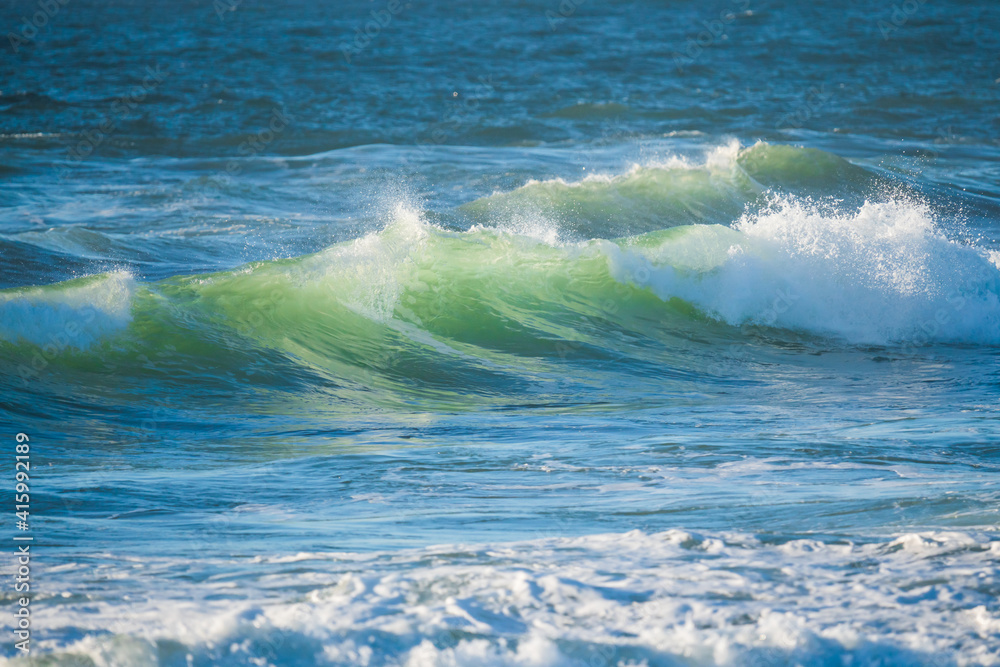 Fototapeta premium Stormy Pacific ocean, beautiful waves in turquoise color close up. Water surface, copy space