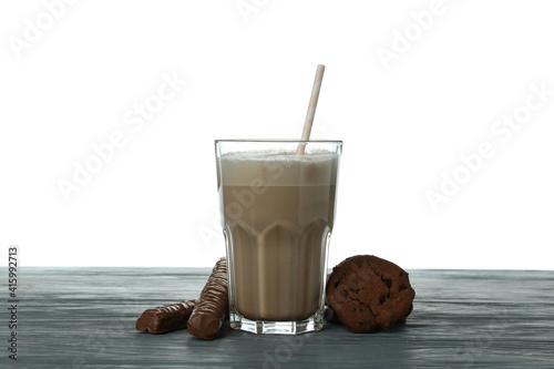 Obraz na płótnie Chocolate milkshake, cookies and chocolate sticks on wooden table isolated on wh