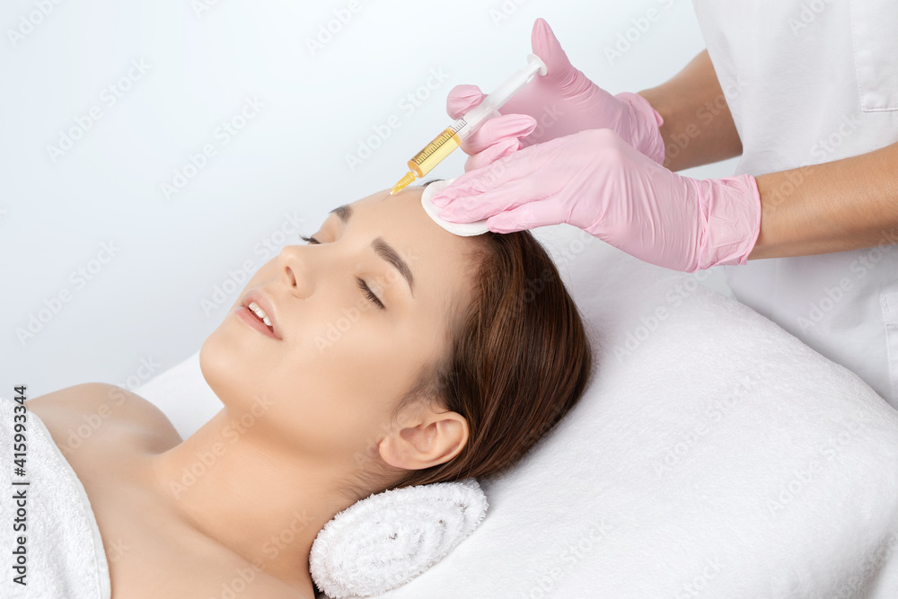 Cosmetologist does prp therapy on the face of a beautiful woman in a beauty salon. Cosmetology concept. Cosmetologist does prp therapy on the face of a beautiful woman in a beauty salon. Cosmetology concept.