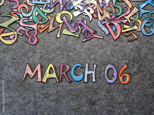 March 6 Calendar Keywords Hand-drawn colorful puzzle with grey furry background top view