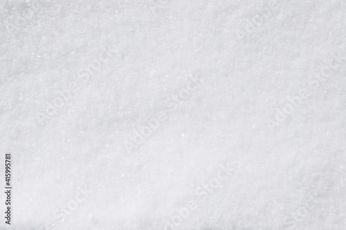 Background, texture of winter white fresh snow. Photo, top view.