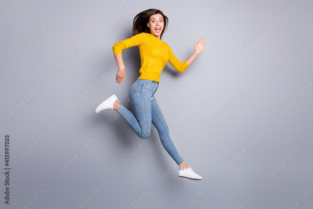 Full size profile photo of hooray brunette nice lady jump run wear sweater jeans sneakers isolated on grey color background