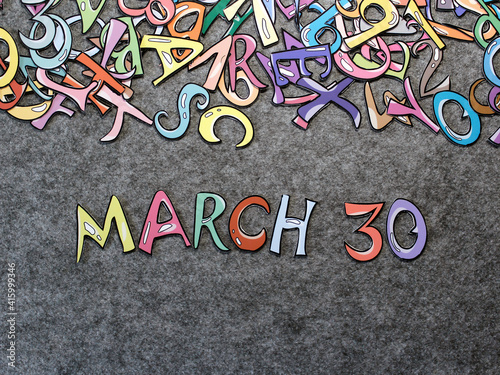 March 30 Calendar Keywords Hand-drawn colorful puzzle with grey furry background top view good for thumbnails