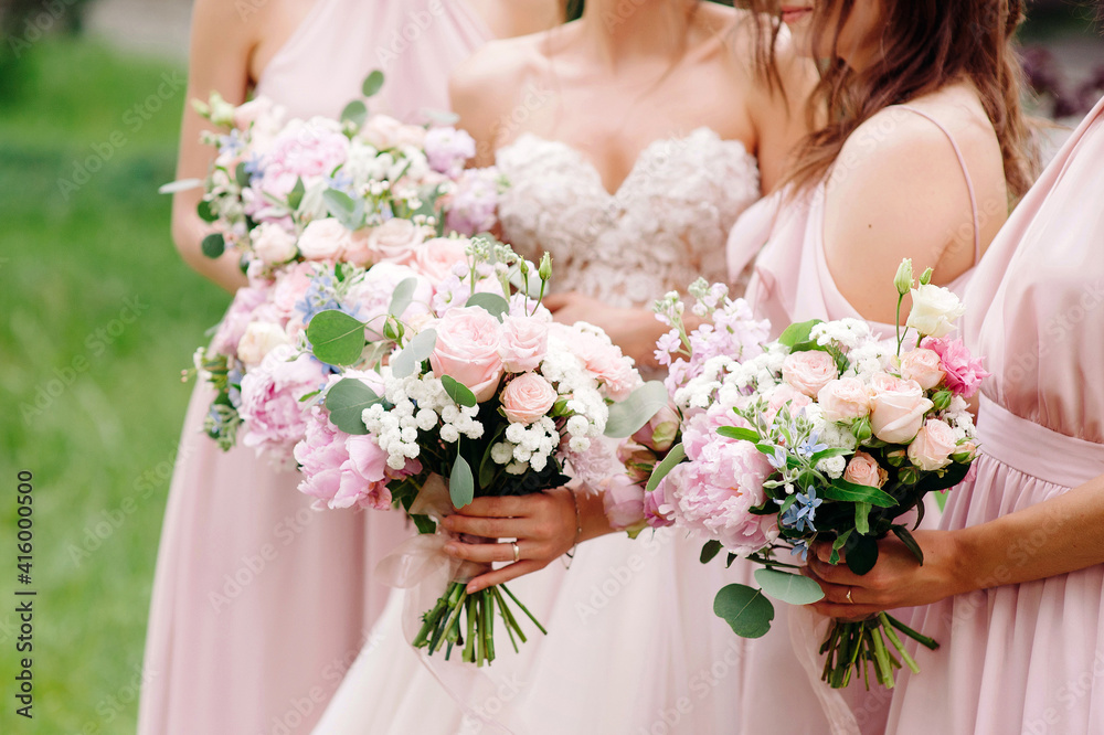 Bridesmaid's bouquets, wedding bouquets closeup. Stylish summer wedding. Contemporary fashion wedding trends. Elegant beautiful style. Modern concept.