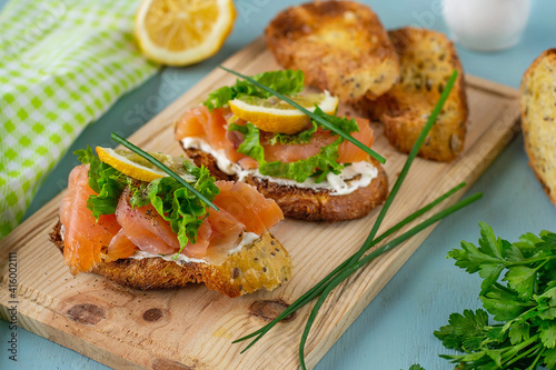 Bruschetta with smoked salmon, cheese, lettuce and chives
