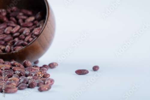 A small wooden bowl full of kidney beans