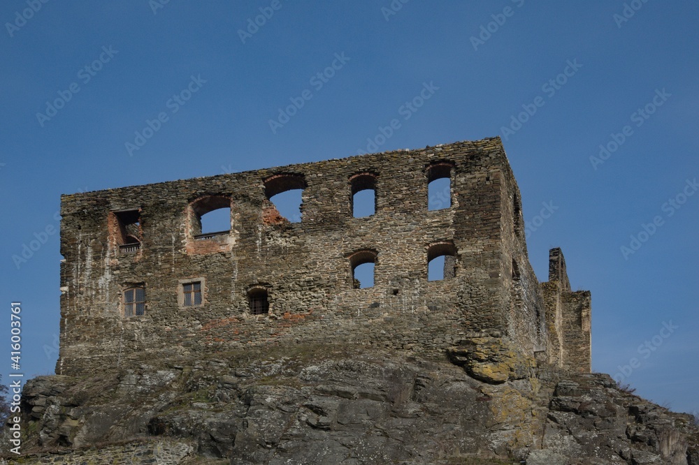 Stone wall with window openings on the ruins of an old castle