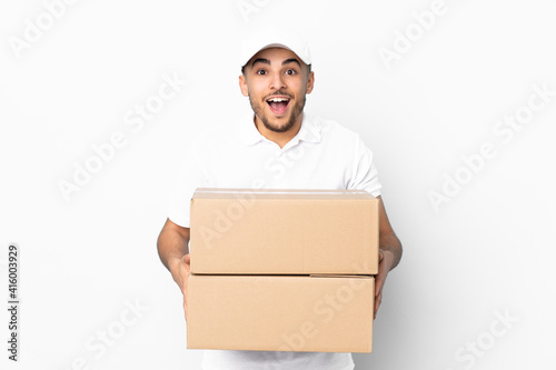 Delivery Arabian man isolated on blue background with surprise facial expression