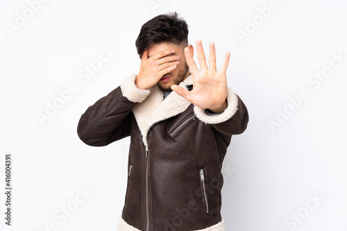Arabian handsome man over isolated background making stop gesture and covering face