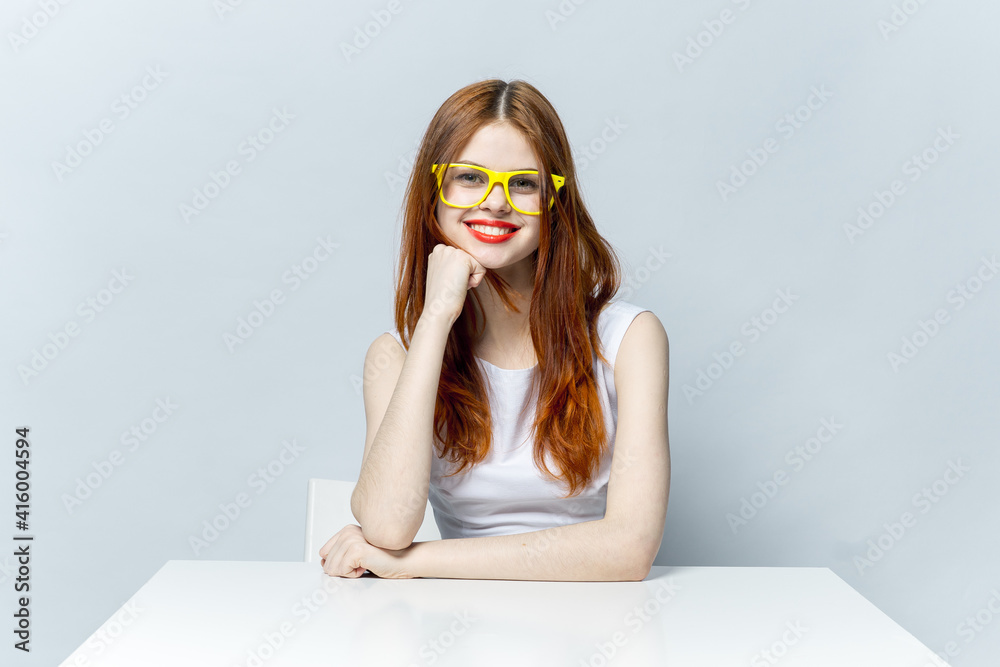 woman in yellow glasses sitting at the table smile emotions desktop woman in yellow glasses sitting at the table smile emotions desktop