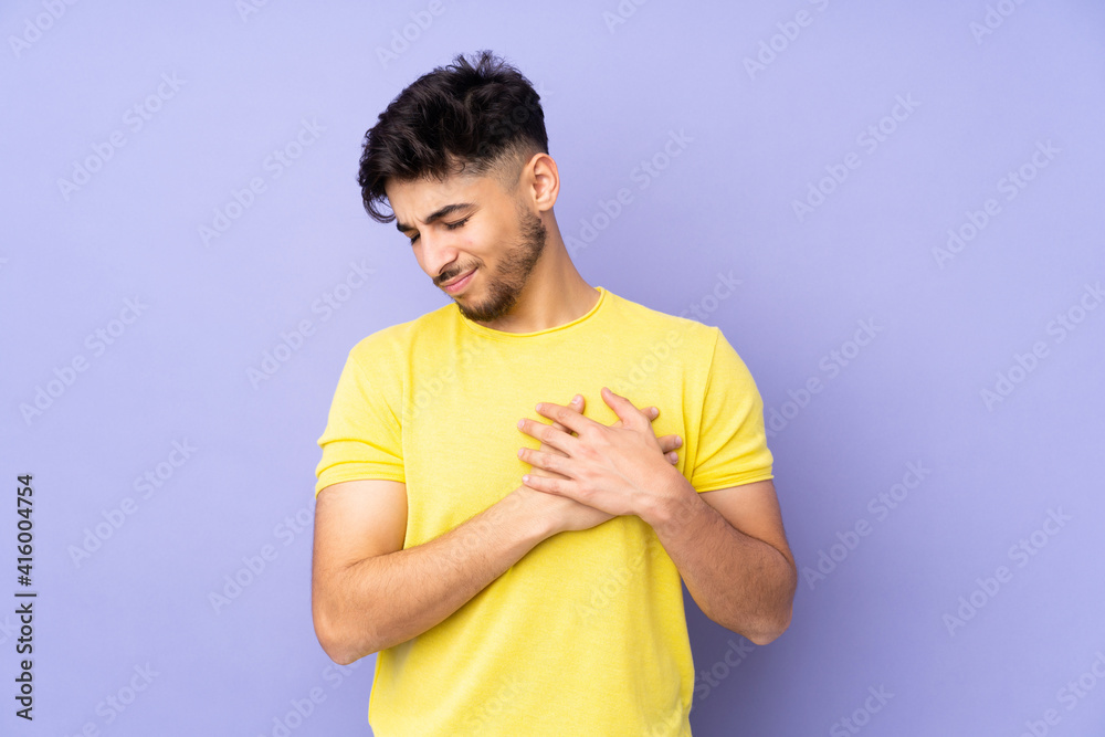 Arabian handsome man over isolated background having a pain in the heart Arabian handsome man over isolated background having a pain in the heart