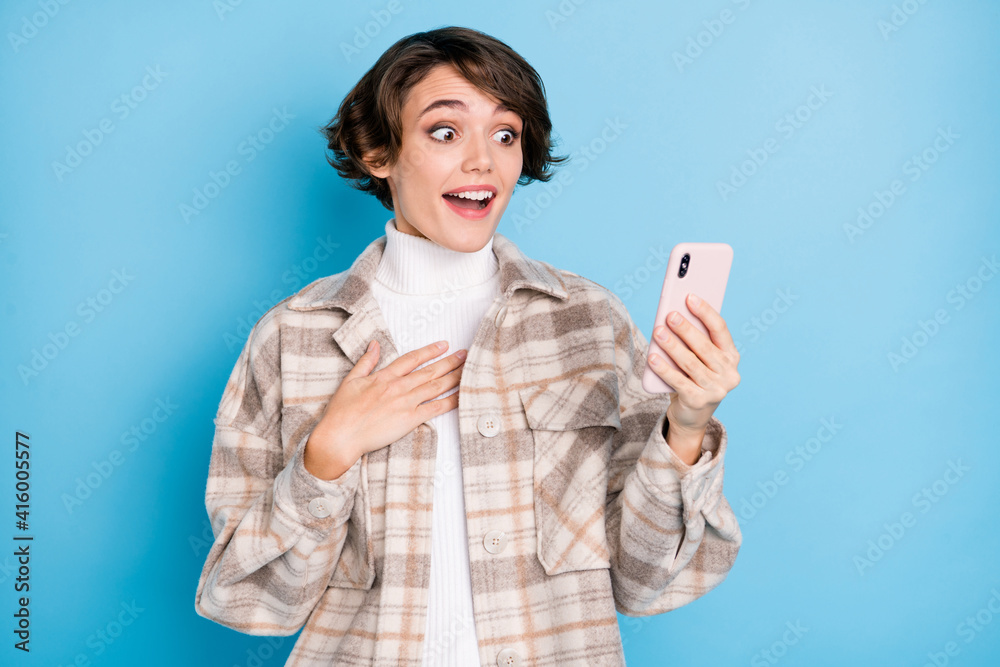 Photo of impressed nice short hairdo lady look telephone wear white shirt isolated on vivid teal color background Photo of impressed nice short hairdo lady look telephone wear white shirt isolated on vivid teal color background
