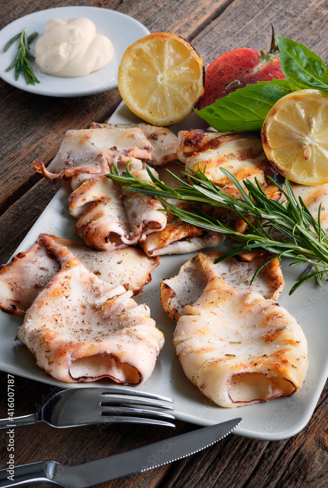 Squid grilled with rosemary sauce on the white plate. Squid grilled with rosemary sauce on the white plate.