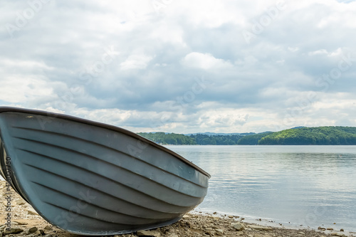 Fototapeta Naklejka Na Ścianę i Meble -  A boat on the shore of the lake